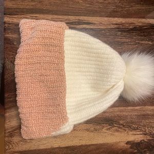 Pink and white puffy winter hat